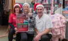 Emma Christie (left) and Lee Whammond (right), from Auchterhouse Country Sports, with Stacey Wallace, Help For Kids manager. The centre is supporting this year's Christmas toy appeal. Image: Craig Chalmers.