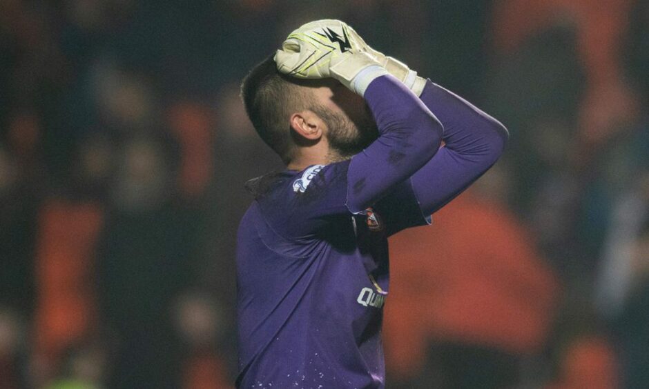 Mark Birighitti with his head in his hands.