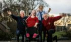 Brenda Ross in her new chair with fundraisers, Yvonne Cargill, John Naysmith (left) and Danny Gentles (right). Image: Mhairi Edwards/ DCThomson