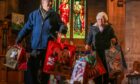 Irene Gillies and Doug Taylor with Angel Tree gifts ready to go. Image: Mhairi Edwards/DC Thomson
