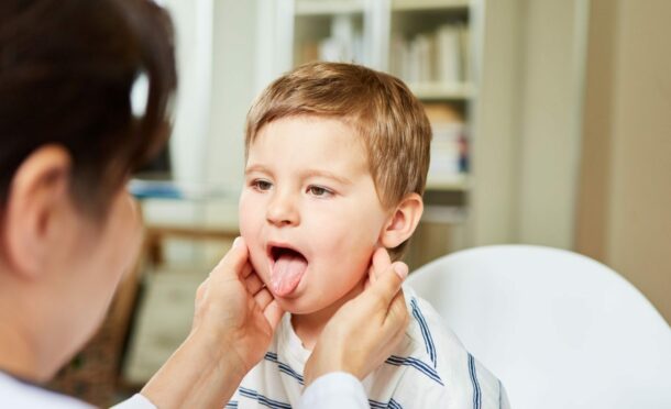 Children should be kept at home if they have symptoms of scarlet fever, which include a sore throat. Image: Shutterstock.