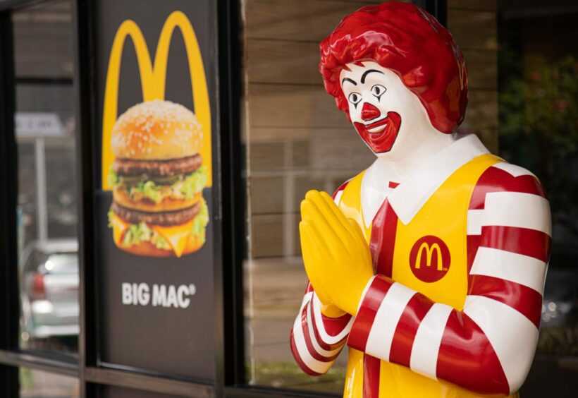 photo shows Ronald McDonald mascot next to a sign for a Big Mac.