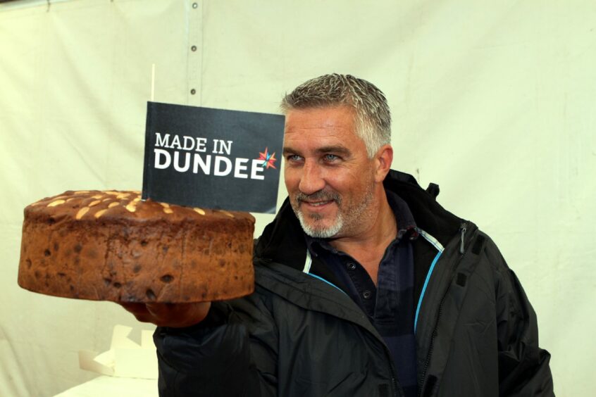 Great British Bake Off star Paul Hollywood inspects a Dundee Cake at the food festival in 2015. 