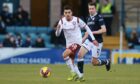 Yasin Ben El-Mhanni of Arbroath is chased down by Cammy Kerr at Dens Park.