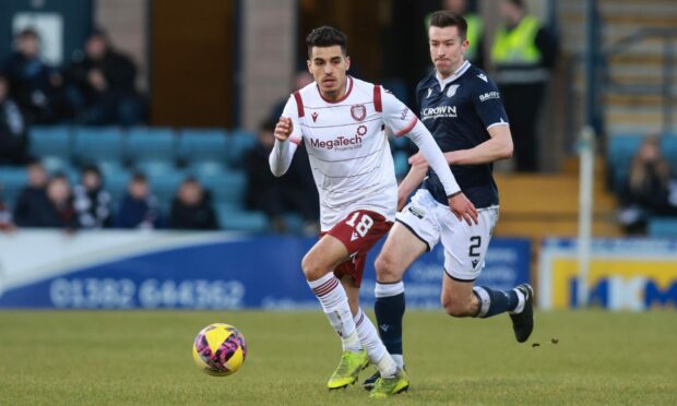 Yasin Ben El-Mhanni of Arbroath is chased down by Cammy Kerr at Dens Park.