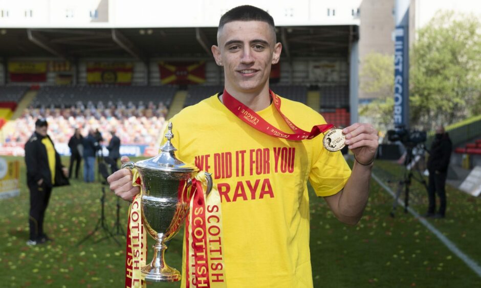 Former Partick Thistle midfielder Charlie Reilly celebrates with the League One trophy and winner's medal.