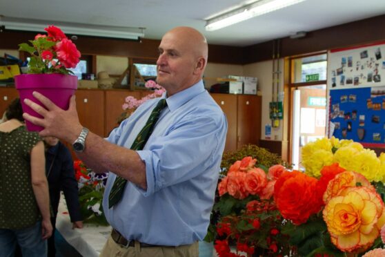 Forfar Horticultural Society chairman Dave Nelson admires blooms at the 2022 show. Image: Paul Reid
