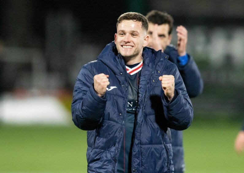 Jamie Gullan clenches both his fists in celebration for Raith Rovers.