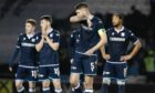 Dejected Dundee players after losing the penalty shootout to St Mirren. Image: SNS.