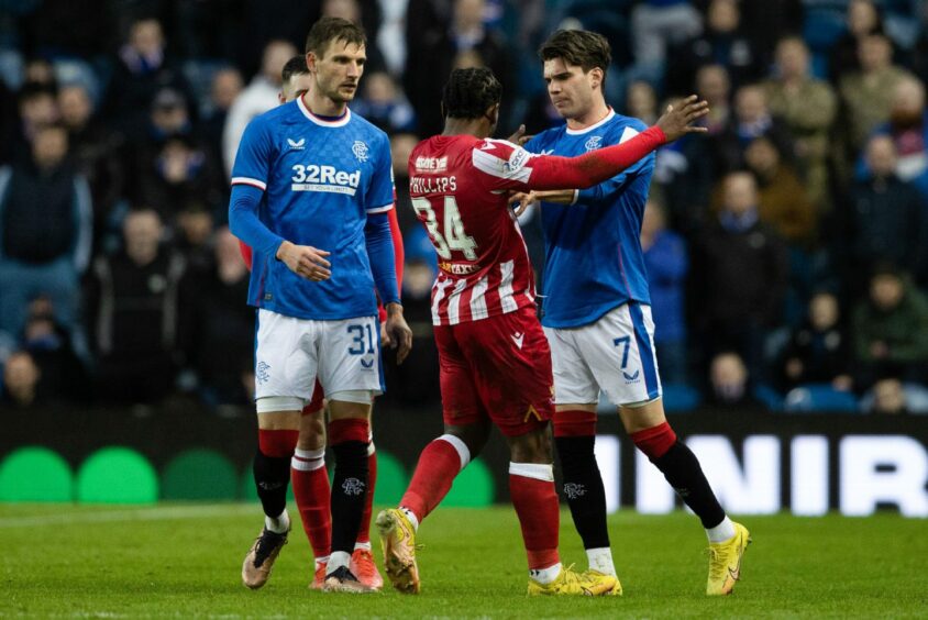 Dan Phillips clashes with Ianis Hagi.