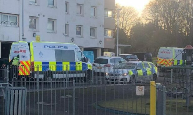 Police at Burnside Court, Lochee, following a "disturbance" at nearby Elders Court. Image: James Simpson/DC Thomson