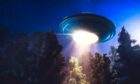 A UFO hovering over a forest. Image: Shutterstock