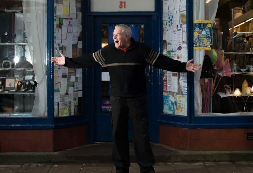 Billy outside his newsagent. 