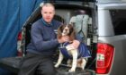 Mike Guthrie with his dog Sam who was attacked by a Husky.