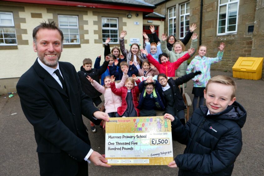 Evening Telegraph editor Dave Lord presented £1,500 to Murroes Primary School. 