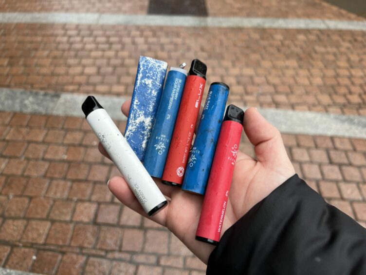 This image shows six disposable vapes collected by climate activists. 