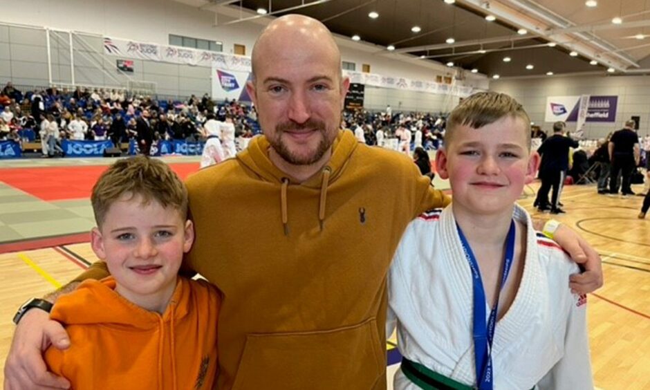 The Dalgety Bay judo twins with their coach Callum Woods