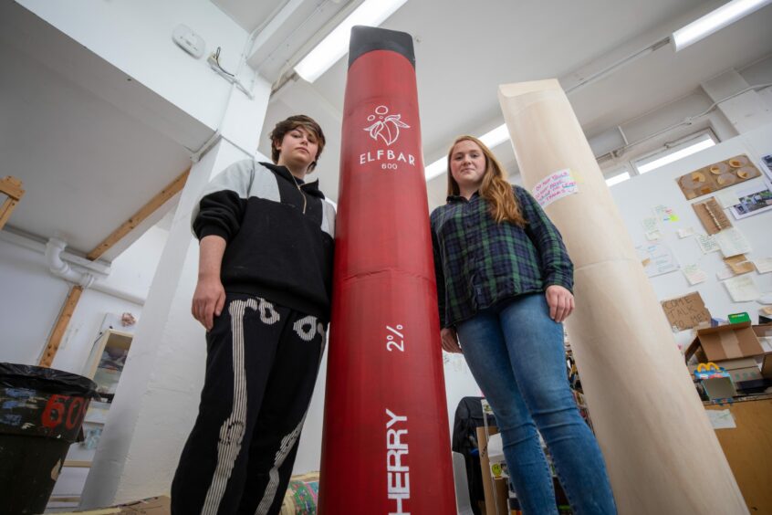 Daniel and environmental campaigner Laura Young with his 7ft disposable vape sculpture in Dundee. 