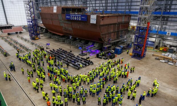 Workers and guests gathered in the assembly room of Babcock's base in Rosyth to mark the beginning of construction with a steel cutting ceremony