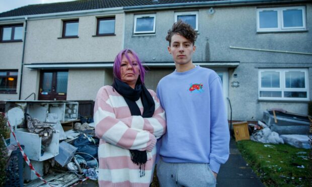 Debbie Dow with son, Cain Dow, who became trapped inside the house after a fire broke out upstairs. Image: Kenny Smith / DC Thomson