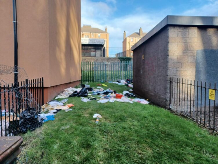 The rubbish strewn over the garden in Dundee. 