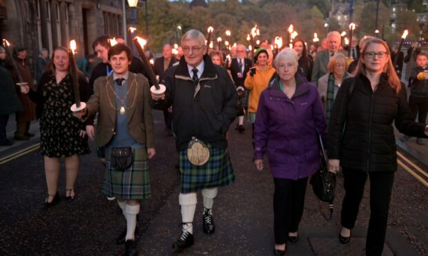 The torchlight procession through the streets of Perth for the opening concert of the 2022 Royal National Mòd.