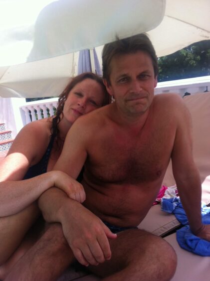 Gordon and Seuna Walker on sun loungers on holiday.