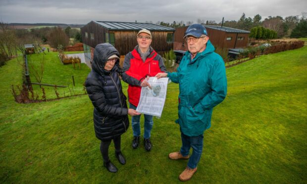 From left, Caroline Cooper, Philip Cooper and Ronnie Hamill at a site next to their homes earmarked for glamping pods.