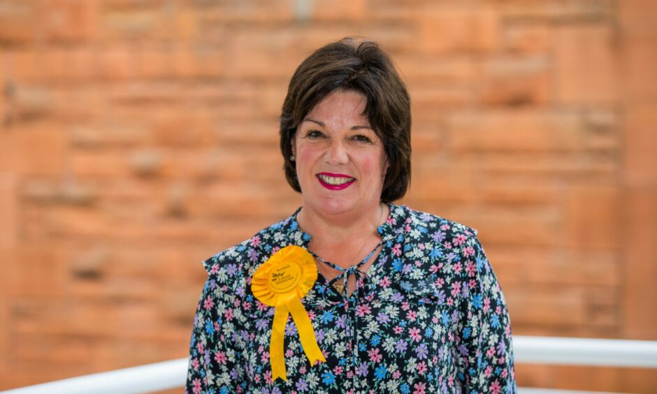 Councillor Claire McLaren at an election count wearing a yellow Lob Dem rosette
