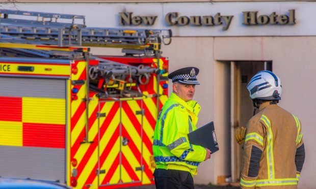 Police and the fire service at the scene of the New County Hotel fire in Perth on January 2.