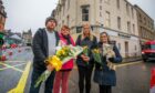 Flower shop owner Craig Burnett with New County Hotel workers Karen Kennedy, Justyna Krokowz and Maggie McLeod and dog Willow. Image: Steve MacDougall/DC Thomson