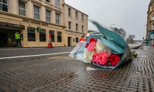 Flowers left outside the New County Hotel in January. Image: Steve MacDougall/DC Thomson