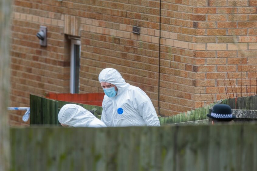 Forensics officers at Troon Avenue, Dundee.