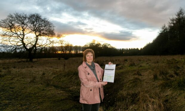 Eleanor Graveling is one of those concerned about the plan, outlined in the poster she is holding.