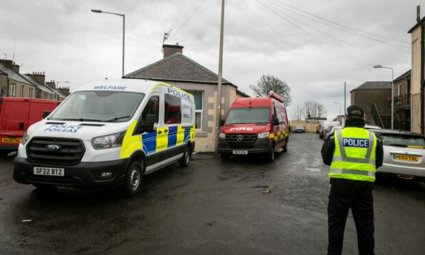 Police and fire investigation officers on Whyte Rose Terrace, Methil, on Thursday. Image: Steve Brown/DC Thomson.