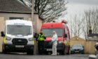 Police and fire investigation officers on Whyte Rose Terrace, Methil, on Thursday. Image: Steve Brown/DC Thomson