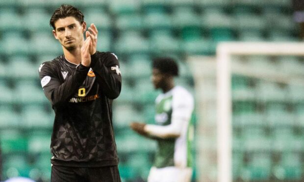 Harkes applauds the sold out United section at Easter Road. Image: SNS