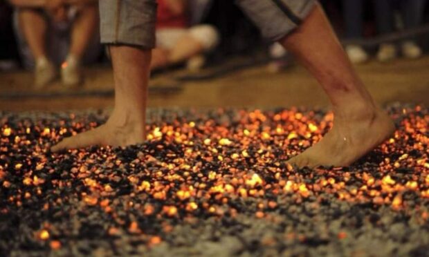 A brave fundraiser takes to the coals at a similar fire walk event. Image: Firewalk Scotland