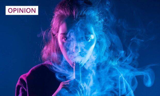 Young woman in a cloud of vape 'smoke'.