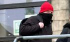 Masked Bonas leaves Kirkcaldy Sheriff Court.