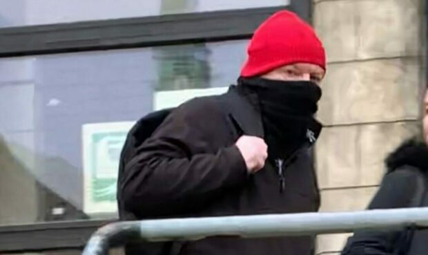 Masked Bonas leaves Kirkcaldy Sheriff Court.
