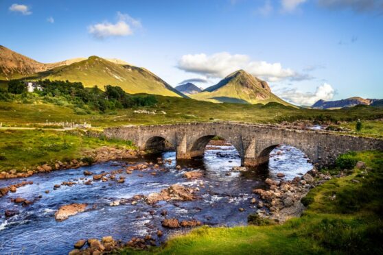 A picture of an old bridge over a river in the Scottish highlands