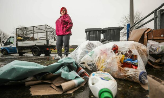 Kate Kerwin with the rubbish on her street. Image:  Mhairi Edwards/ DC Thomson