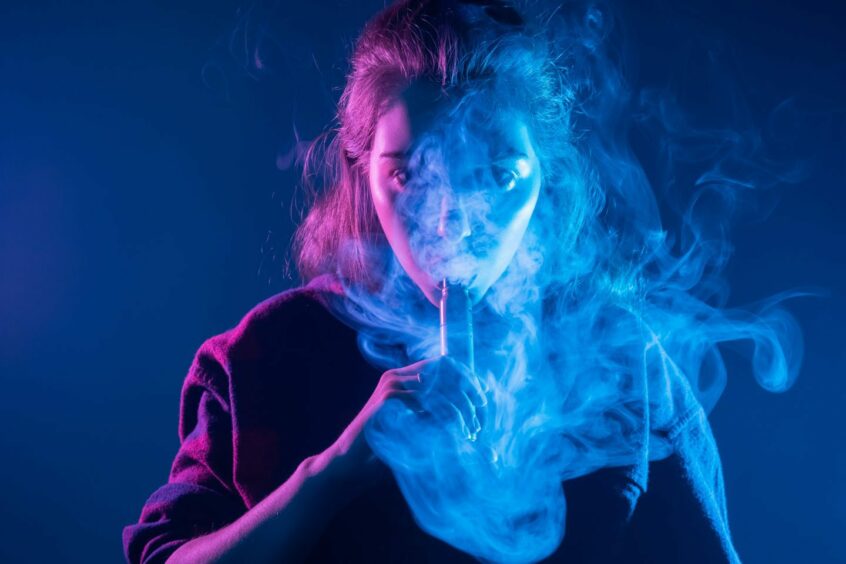 A woman smoking a vape