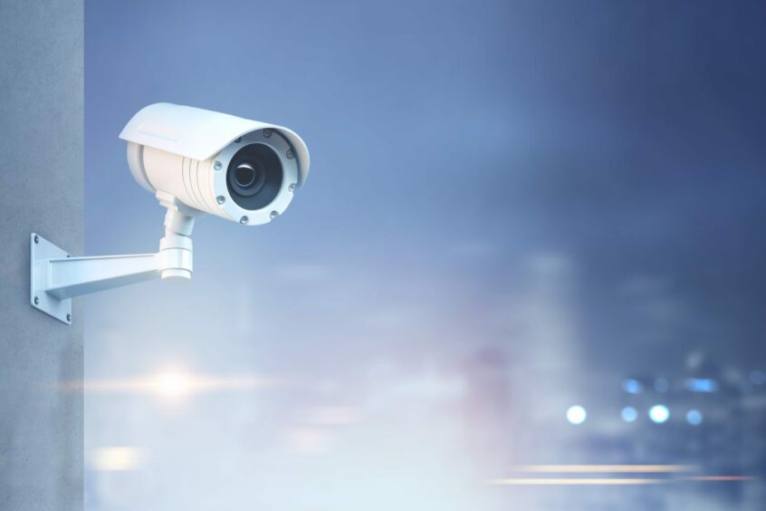 CCTV camera on blurred streetscape
