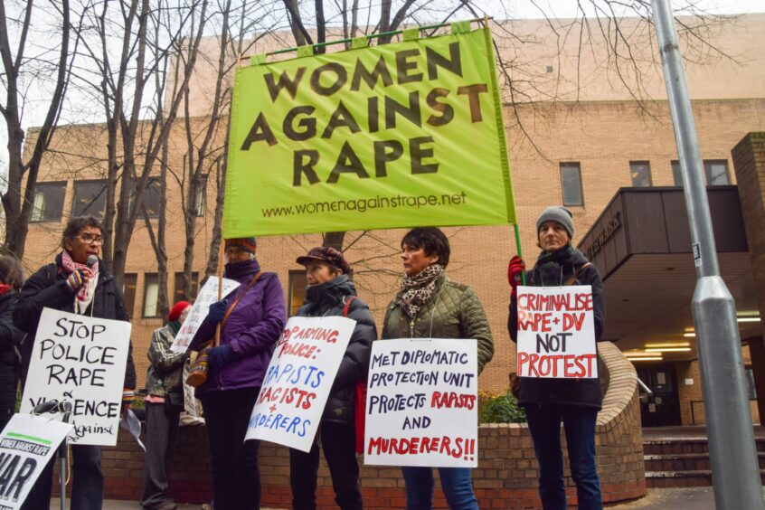 protesters outside Southwark Crown Court carrying banners with slogans such as 'Women against rape'.