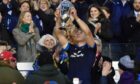 Jamie Ritchie accepts the Doddie Weir Cup from Kathy Weir after Scotland's win.