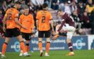 Hearts' Andy Halliday complains about a tackle by Dundee United's Ryan Edwards at Tynecastle. Image: Ross Parker/SNS