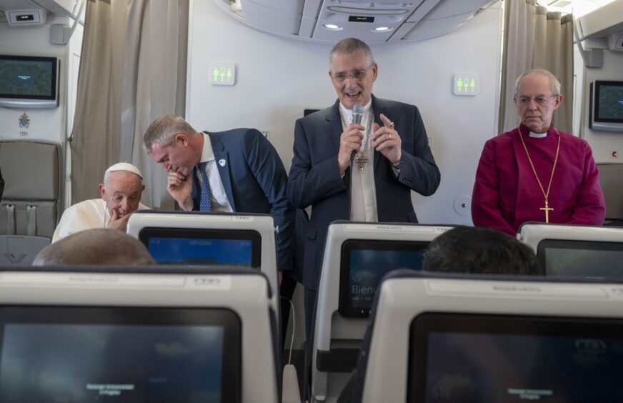 Dr Iain Greenshields addresses passengers on board the Papal plane to South Sudan.