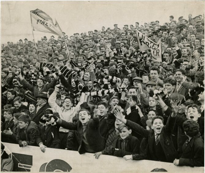 black and white 1960s photo of Dundee United fans on the packed terraces.